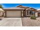 Charming single-story home with a two-car garage and desert landscaping in a sunny setting at 16120 N 86Th Ln, Peoria, AZ 85382