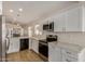Well-equipped kitchen with stainless steel appliances, sleek countertops, and stylish white cabinetry at 16120 N 86Th Ln, Peoria, AZ 85382