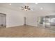 Spacious living room featuring tile flooring and a sliding glass door to the backyard at 16120 N 86Th Ln, Peoria, AZ 85382