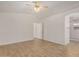 The main bedroom features wood-look tile floors, a ceiling fan, and neutral paint at 16120 N 86Th Ln, Peoria, AZ 85382