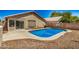 Inviting backyard pool featuring a basketball hoop and low-maintenance desert landscaping at 16120 N 86Th Ln, Peoria, AZ 85382