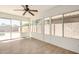 Sunroom with tile floors and many windows looking out to the backyard and pool at 16120 N 86Th Ln, Peoria, AZ 85382