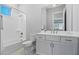 Bright bathroom featuring a shower/tub combination, white vanity and large mirror at 17376 W Wildwood St, Surprise, AZ 85388