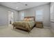 Cozy primary bedroom showcasing a neutral color palette, ceiling fan, and shuttered windows at 17376 W Wildwood St, Surprise, AZ 85388