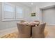 Bright dining room showcasing shuttered windows, a round table, and four comfortable chairs at 17376 W Wildwood St, Surprise, AZ 85388