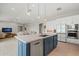 An open-concept kitchen boasts a large island, stainless appliances, and white cabinetry at 17376 W Wildwood St, Surprise, AZ 85388