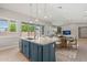 Modern kitchen island with pendant lighting and stainless steel appliances in an open-concept dining and living space at 17376 W Wildwood St, Surprise, AZ 85388