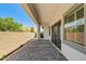 Covered patio with brick pavers and view of backyard and blue skies at 17376 W Wildwood St, Surprise, AZ 85388