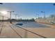 Tennis court with a clear blue sky. This amenity includes benches and new lighting at 17376 W Wildwood St, Surprise, AZ 85388