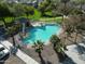 A lovely aerial perspective of the community pool surrounded by lush landscaping and residences at 17802 N 114Th Ln, Surprise, AZ 85378