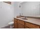 Practical bathroom featuring a vanity with ample counter space and storage, alongside a toilet at 17802 N 114Th Ln, Surprise, AZ 85378