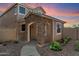 Inviting two-story home featuring a stone-accented entrance, neutral paint, and desert landscaping at 17802 N 114Th Ln, Surprise, AZ 85378