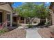 Landscaped front yard with a charming home, stone facade, and inviting walkway at 17802 N 114Th Ln, Surprise, AZ 85378