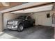 Attached garage featuring an F-150 pickup truck and plenty of room for vehicle storage and parking at 17802 N 114Th Ln, Surprise, AZ 85378