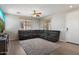 Spacious living room featuring a plush sectional sofa, ceiling fan, and neutral tones at 17802 N 114Th Ln, Surprise, AZ 85378