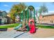 Vibrant community playground with slides and play structures, surrounded by well-maintained landscaping and charming homes at 17802 N 114Th Ln, Surprise, AZ 85378