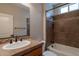 Bathroom featuring warm wall and tile colors, and shower-tub combo at 1809 E Adelante Way, Queen Creek, AZ 85140