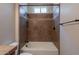 Bathroom featuring warm colored tiles and a shower-tub combo at 1809 E Adelante Way, Queen Creek, AZ 85140
