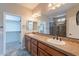 Primary bathroom with dual sinks, granite counters, and access to a walk-in shower at 1809 E Adelante Way, Queen Creek, AZ 85140