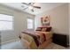 Cozy bedroom with a ceiling fan and views of the exterior neighborhood at 1809 E Adelante Way, Queen Creek, AZ 85140