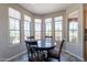 Charming breakfast nook featuring a round table surrounded by many bright windows at 1809 E Adelante Way, Queen Creek, AZ 85140