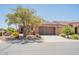 Charming home featuring a well-kept front yard and a two-car garage, set on a sunny day at 1809 E Adelante Way, Queen Creek, AZ 85140