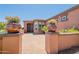 Inviting entryway with well-kept plants and bushes leading to the front door at 1809 E Adelante Way, Queen Creek, AZ 85140