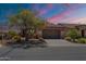 Charming single-story home showcasing a xeriscaped front yard, concrete driveway and a neutral-toned exterior paint at 1809 E Adelante Way, Queen Creek, AZ 85140