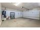 Spacious garage featuring an electric door opener, water heater, shelving, and ample room for storage at 1809 E Adelante Way, Queen Creek, AZ 85140