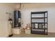Garage interior showing a water heater, shelving, and storage containers along a white wall at 1809 E Adelante Way, Queen Creek, AZ 85140