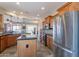 Bright kitchen with stainless steel appliances, wood cabinets, and a kitchen island at 1809 E Adelante Way, Queen Creek, AZ 85140