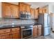 Contemporary kitchen with stainless steel appliances, wood cabinets, and tile backsplash at 1809 E Adelante Way, Queen Creek, AZ 85140