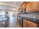 Modern kitchen with stainless steel appliances, dark countertops, and backsplash at 1809 E Adelante Way, Queen Creek, AZ 85140