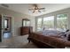 Comfortable main bedroom featuring ample natural light from the surrounding windows at 1809 E Adelante Way, Queen Creek, AZ 85140