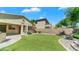 Backyard showcasing artificial grass and stone walkway at 2031 W Periwinkle Way, Chandler, AZ 85248