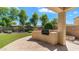 Covered backyard patio area with built-in grill and stone flooring at 2031 W Periwinkle Way, Chandler, AZ 85248