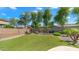 Beautiful backyard featuring artificial grass, desert landscaping, and a block fence at 2031 W Periwinkle Way, Chandler, AZ 85248