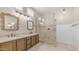 Bathroom with dual vanities, a glass-enclosed shower, and stylish tile work at 2031 W Periwinkle Way, Chandler, AZ 85248