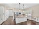 Open-concept kitchen with white cabinetry, granite counters, stainless appliances, and hardwood flooring at 2031 W Periwinkle Way, Chandler, AZ 85248
