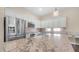 Close-up of a kitchen island featuring white cabinetry, granite countertops, and stainless steel appliances at 2031 W Periwinkle Way, Chandler, AZ 85248