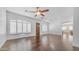 Spacious living room featuring hardwood floors, a ceiling fan, and plenty of natural light at 2031 W Periwinkle Way, Chandler, AZ 85248