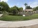 Scenic community pond with grassy banks and a bridge in the distance, creating a tranquil setting at 2031 W Periwinkle Way, Chandler, AZ 85248