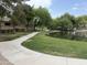 Scenic community pond with walking path, green lawn, and a charming bridge at 2031 W Periwinkle Way, Chandler, AZ 85248