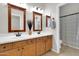 Bathroom features a dual sink vanity with wooden cabinets and framed mirrors at 20423 S 186Th St, Queen Creek, AZ 85142