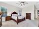 Bedroom features a large bed frame, a ceiling fan, and two dressers at 20423 S 186Th St, Queen Creek, AZ 85142