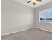 Neutral bedroom with carpeted floors, a ceiling fan, and a window providing natural light at 20423 S 186Th St, Queen Creek, AZ 85142