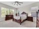 Cozy bedroom with a traditional bed frame, two bedside tables, and a dresser at 20423 S 186Th St, Queen Creek, AZ 85142