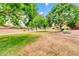 Well-maintained community lawn surrounded by mature trees and residential properties at 20423 S 186Th St, Queen Creek, AZ 85142