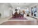 Open dining room with chandelier, wood table, red rug, and kitchen view at 20423 S 186Th St, Queen Creek, AZ 85142