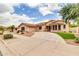 Inviting home boasts a circular driveway, tile roof, and desert-friendly landscaping at 20423 S 186Th St, Queen Creek, AZ 85142
